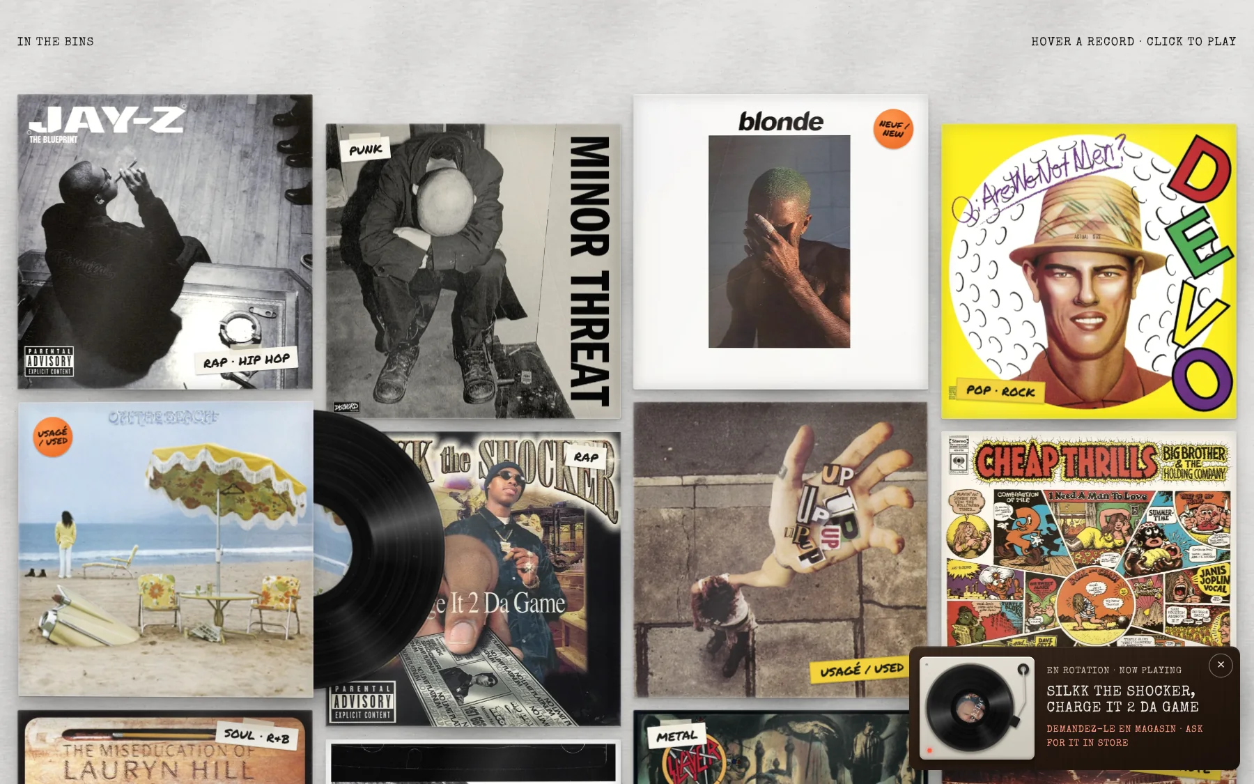 A wall of worn album covers with genre stickers, one record sliding out of its sleeve, and a turntable player in the corner