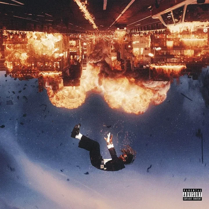Album cover: a figure falling beneath an upside-down burning city