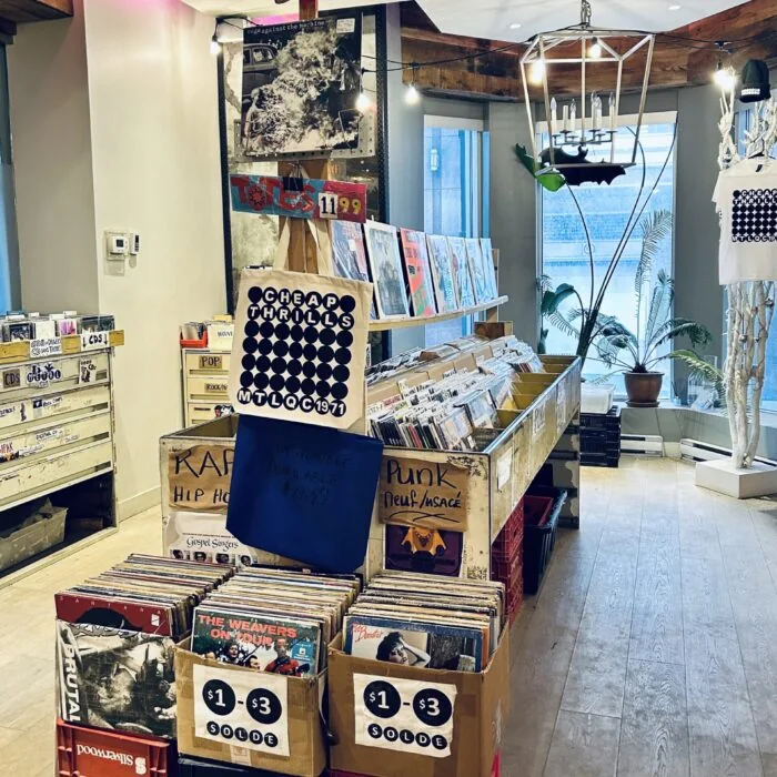 $1–$3 sale boxes and Cheap Thrills tote bags on the shop floor