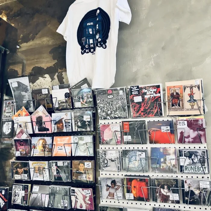 CD racks under a Cheap Thrills t-shirt